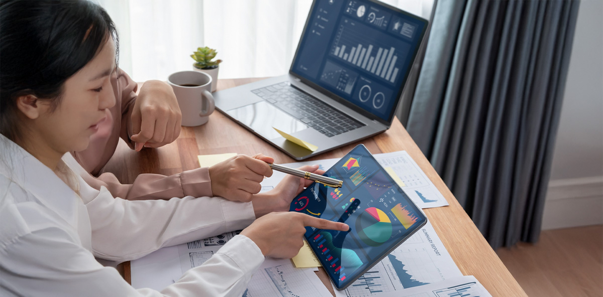 Professionals analyzing partner data insights on digital dashboards using PRM Software.