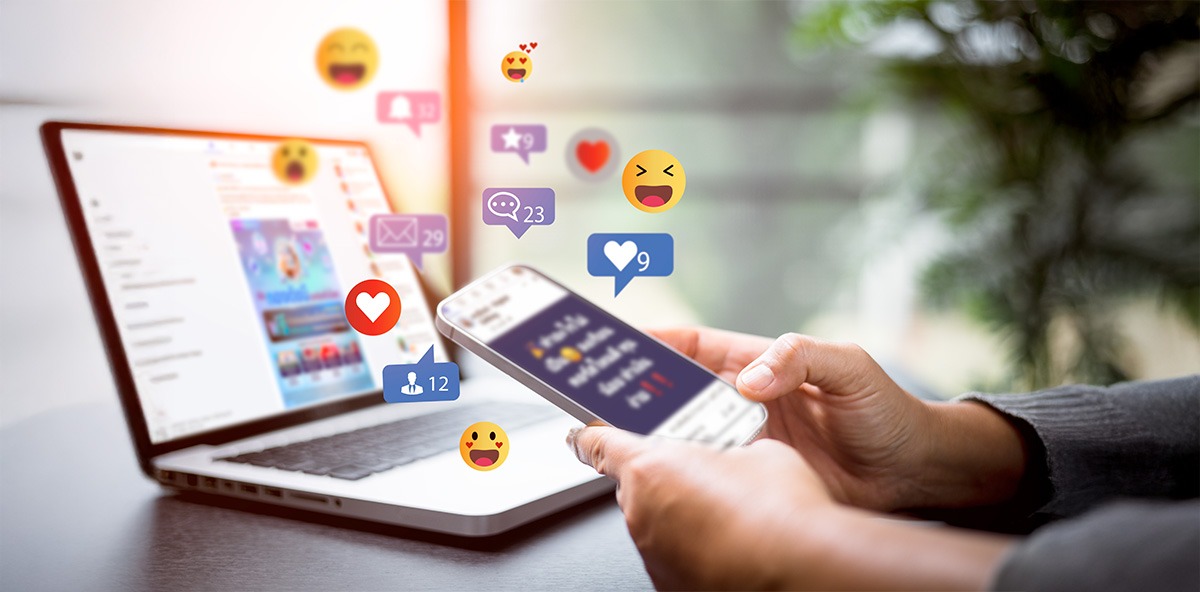 Hands using phone with social media icons, showing Partnering through digital engagement.