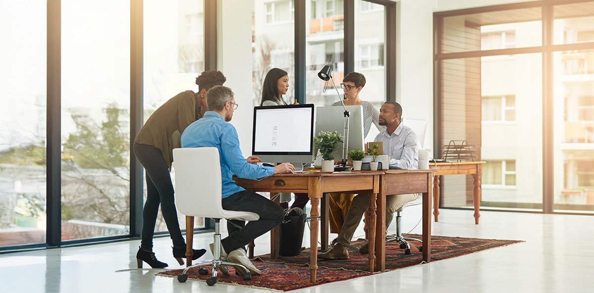 Team collaborating in modern office, reflecting innovation and teamwork in Partnering.