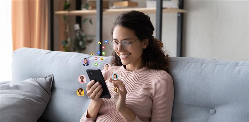 Smiling woman engaging on phone, illustrating the power of Partnering through digital connections.