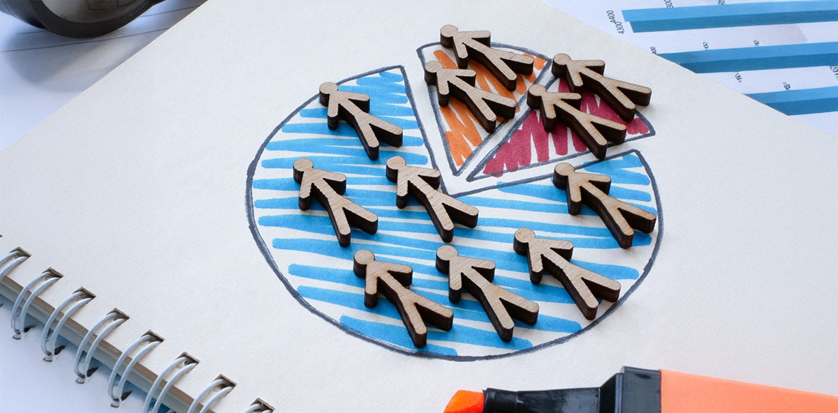 Wooden human icons on a pie chart illustrating partner marketing categories and ecosystem segmentation.