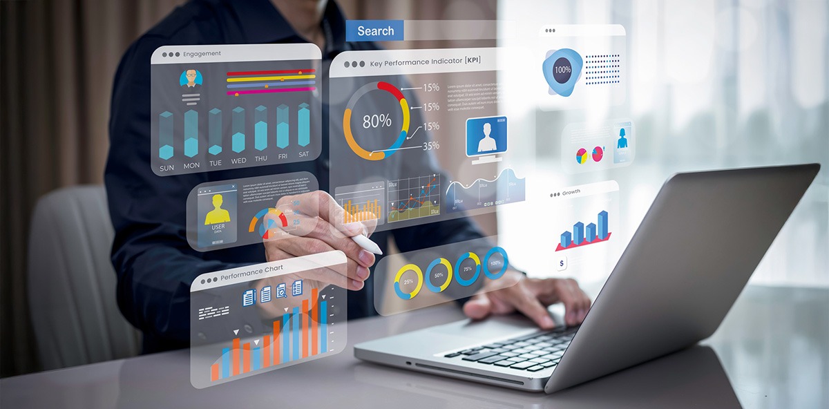 Professional analyzing partner KPIs and performance charts on a laptop with interactive digital dashboards.