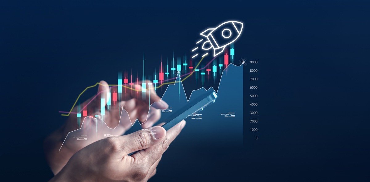 Hands using a smartphone with rising digital charts and a rocket icon, symbolizing accelerated growth in the partner ecosystem.
